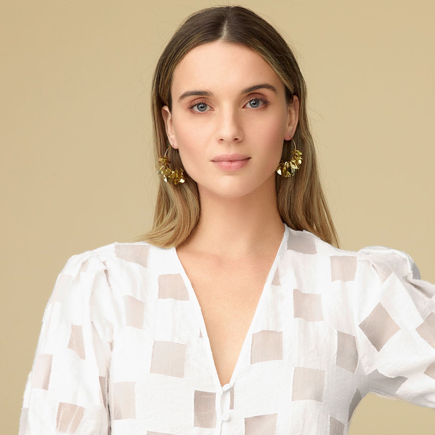 Metallic Gold Wavy Sequins on Thin Gold Hoop on Blonde Model with White Blouse On