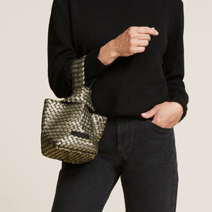 Gold and Black Woven Neoprene Bag Styled on Model in Black Sweater and Jeans