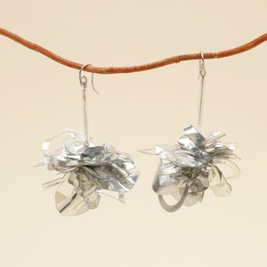 Clustered Sequin Drop Earrings Hanging From Branch with Cream Background