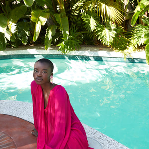 Silver Sequin Wing Stud Earrings Styled on Model with Pink Dress at a Pool