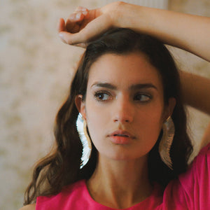 Silver Sequin Wing Stud Earrings Styled on Model in a Pink Dress