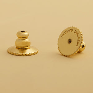 Gold Earring Backs Styled on Tan Background