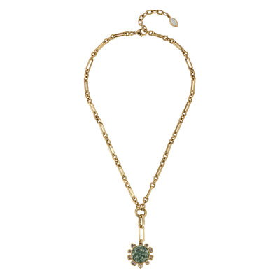 A gold chain necklace featuring a central gold-toned flower-like setting with a round green gemstone and small clear accent stones, displayed on a clean white background.