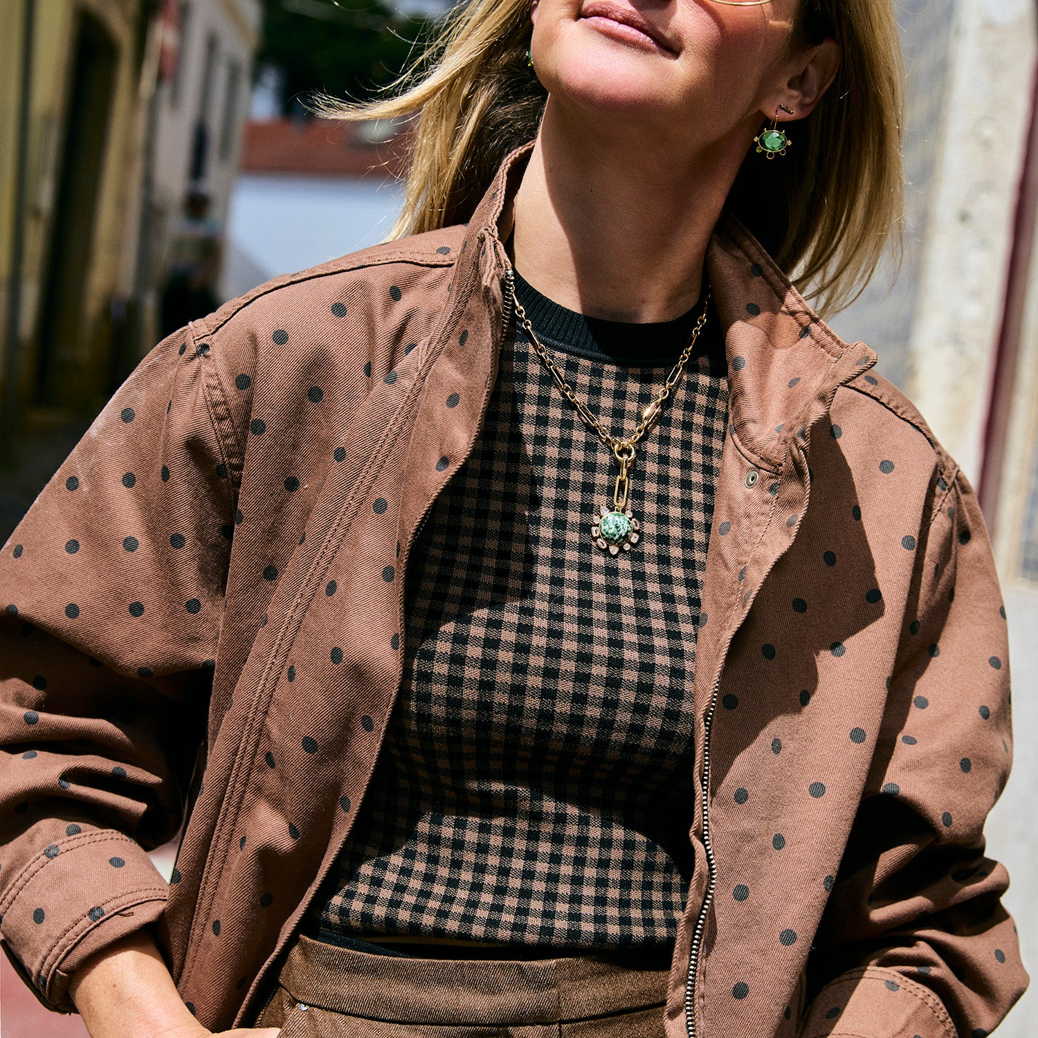 Model wearing green semi precious stone mini sized pendant on a gold link chain necklace