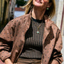 Model wearing green semi precious stone mini sized pendant on a gold link chain necklace