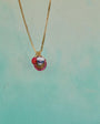 Necklace with a colorful pendant on a light blue background