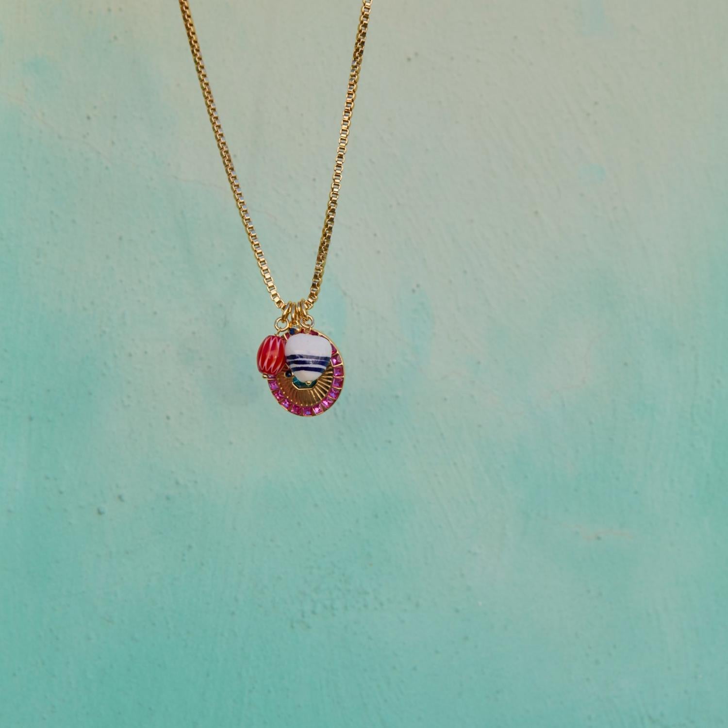 Necklace with a colorful pendant on a light blue background