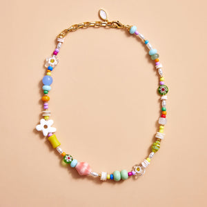 Multi-Colored Beaded Strand Necklace on Cream Background