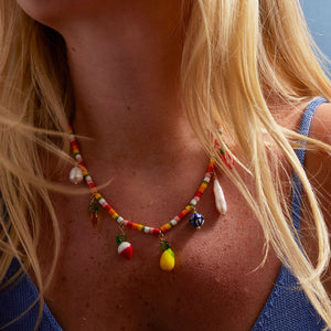 Beaded Charm Necklace with Fruit Charms and Pearls Styled on Model's Neck