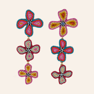 Multi-Colored Beaded Flower Triple Drop Statement Earrings on Tan Background