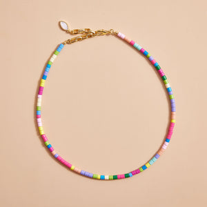 Multi-Colored Beaded Strand Necklace on Cream Background
