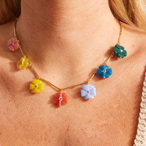 Multi-Colored Flower Charms on Gold Chain Necklace on Model's Neck