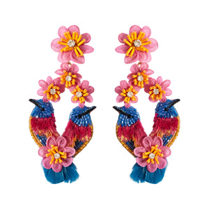 Multi-colored flower and bird embroidered drop earrings on flat white background