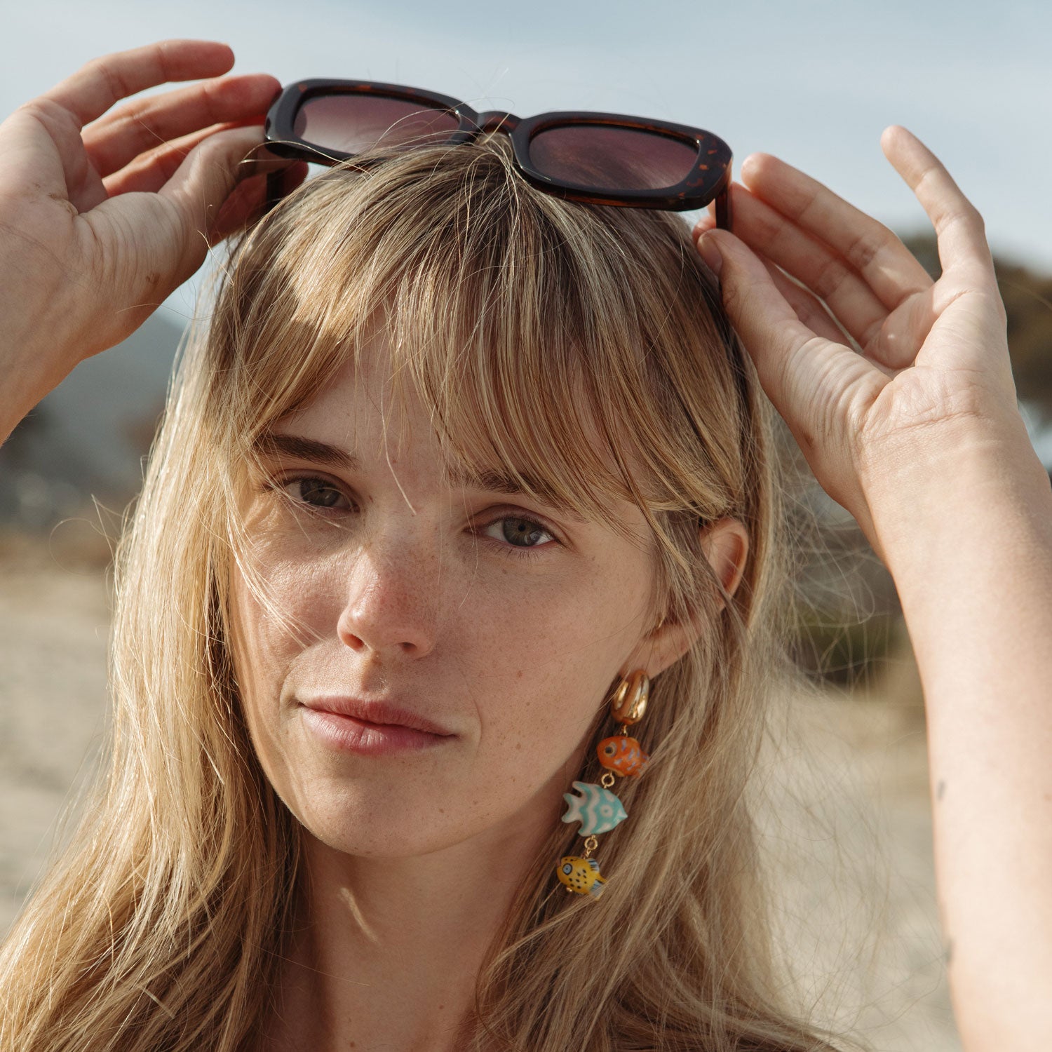 Painted Fish Drop Earrings Styled on Model