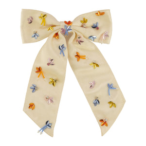 Multi-colored sequin and bead embroidered hair bow on flat white background