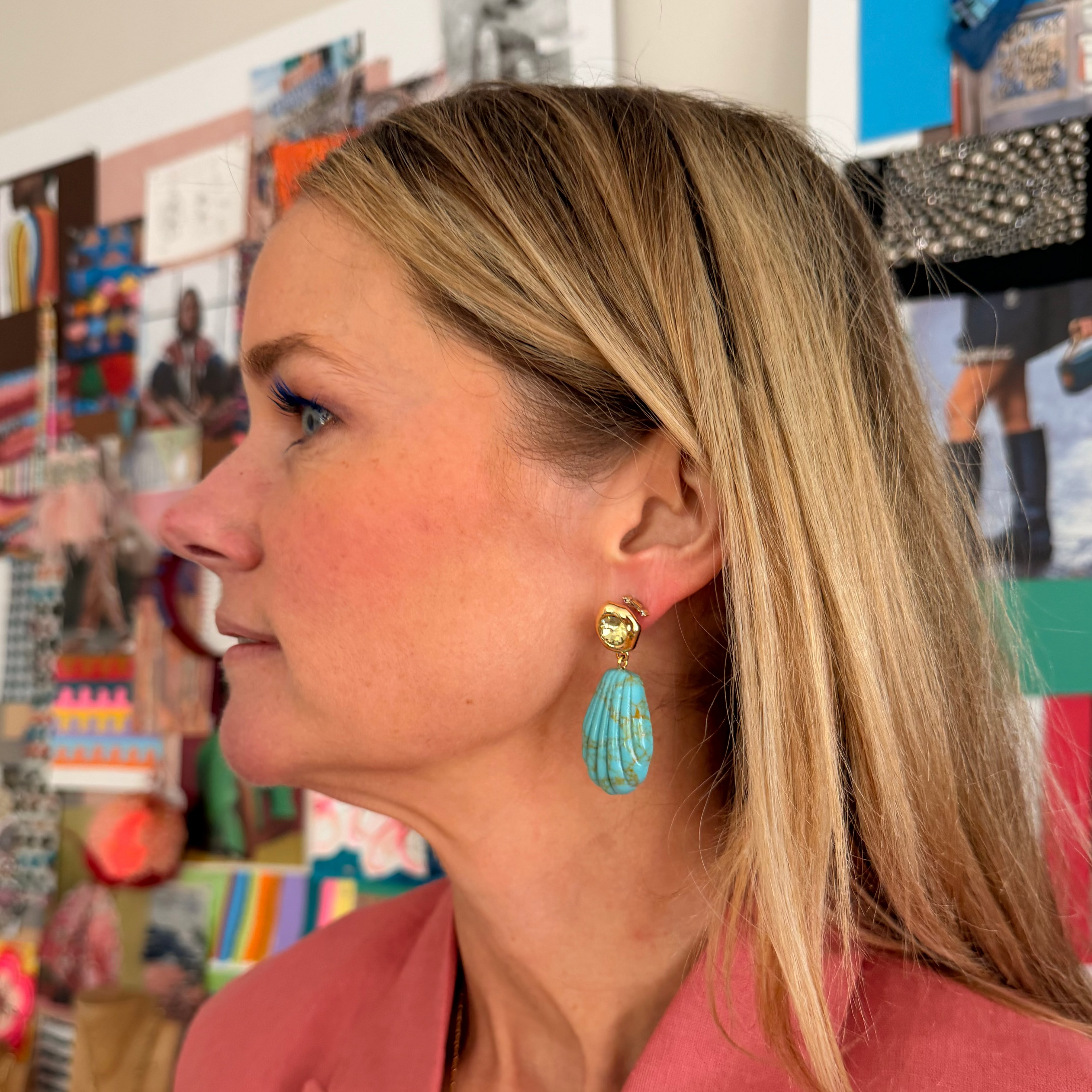 Woman wearing turquoise earrings in a colorful store setting