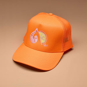 Neon Orange Trucker Hat with Shrimp Cocktail Embroidery on Tan Background