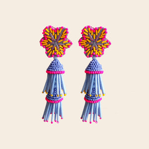 Purple, Neon Pink, and Orange Beaded and Embroidered Flower Tassel Drop Earrings on Tan Background