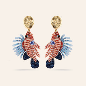 Brown Neutral and Blue Beaded and Embroidered Lionfish Drop Earrings on Tan Background