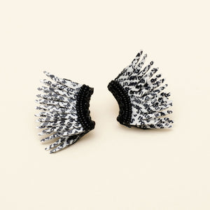 Black and White Newspaper Print Sequin Wing Earrings on Cream Background