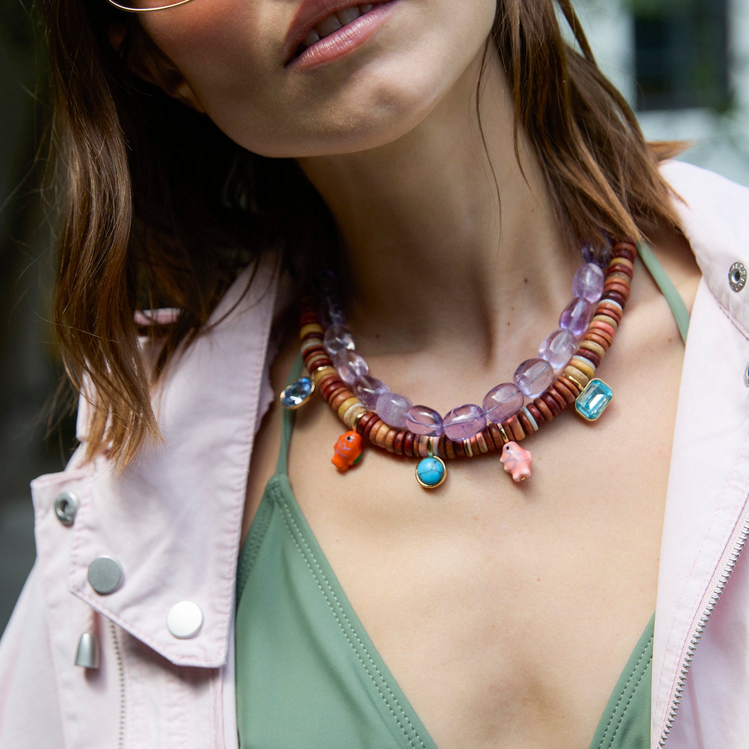 Model wearing beaded necklaces layered around her neck