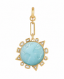 A gold pendant charm featuring a round light blue carved stone in the center, surrounded by a gold sunburst frame with small clear inset stones, shown on a plain white background.