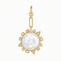 A gold pendant featuring a large, round, lustrous white pearl surrounded by a geometric gold border with small clear stones, suspended from a gold chain on a plain white background.