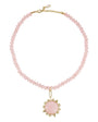 Necklace with pink beads and a pink stone pendant on a white background