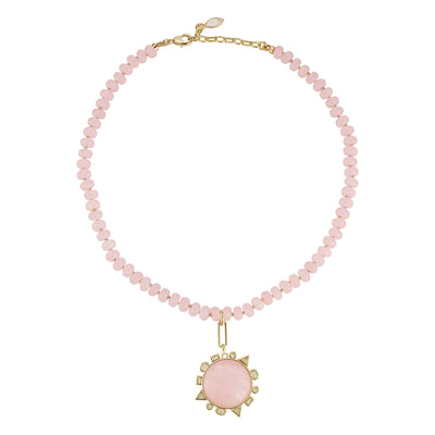 Necklace with pink beads and a pink stone pendant on a white background