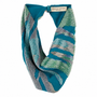 A beaded infinity scarf featuring a teal blue base with geometric patterns of green, gray, and silver beads, shown on a plain white background.
