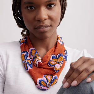 Orange Scarf Necklace with Orange, Pink, and Blue Beaded Flower Embroidery Styled on Model