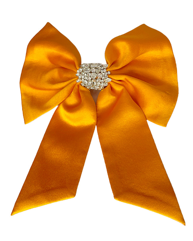 Orange and Clear Crystal Hair Bow on Flat White Background