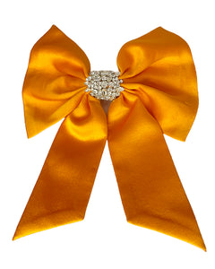 Orange and Clear Crystal Hair Bow on Flat White Background