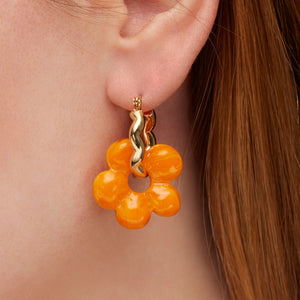 Orange and Yellow Marbled Glass Flower Charm Earrings on Gold Hoop On Model's Ear