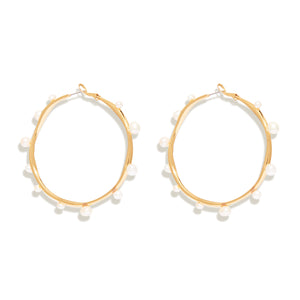 Organic Shaped Gold and Pearl Hoop Earrings On Flat White Background