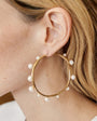Organic Shaped Gold and Pearl Hoop Earrings Styled on Blonde Model's Ear