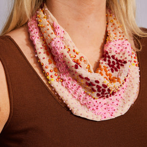 Peachy Pink Scarf Necklace with Red, Pink, Yellow, and Orange Beading and Embroidery Scarf Necklace Styled on Model in Brown Top 