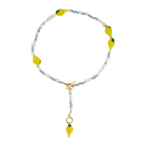 Pearl, Blue and White Bead, and Yellow Lemon Bead Strand Necklace on Flat White Background