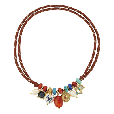 A bohemian-style multi-strand necklace featuring brown cords, colorful beads, faux pearls, and various decorative charms including a Star of David, a Star of Bethlehem, and a gold-toned mezuzah case, displayed on a clean white background.