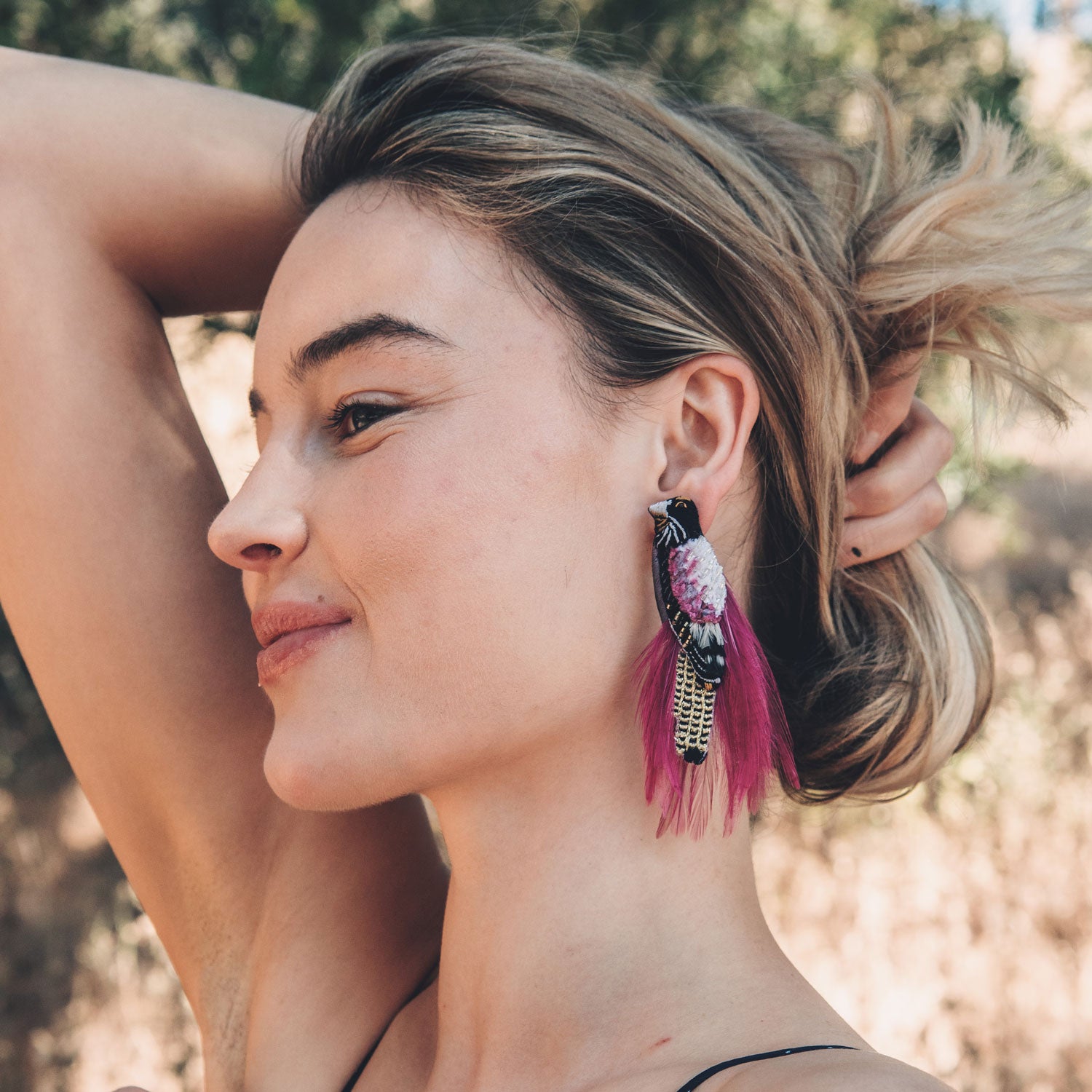 Pair of Embroidered Bird Earrings with Pink Feathers Styled on Model