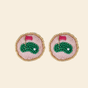 Pink, Green, and Gold Beaded Putting Green Stud Earrings on Tan Background