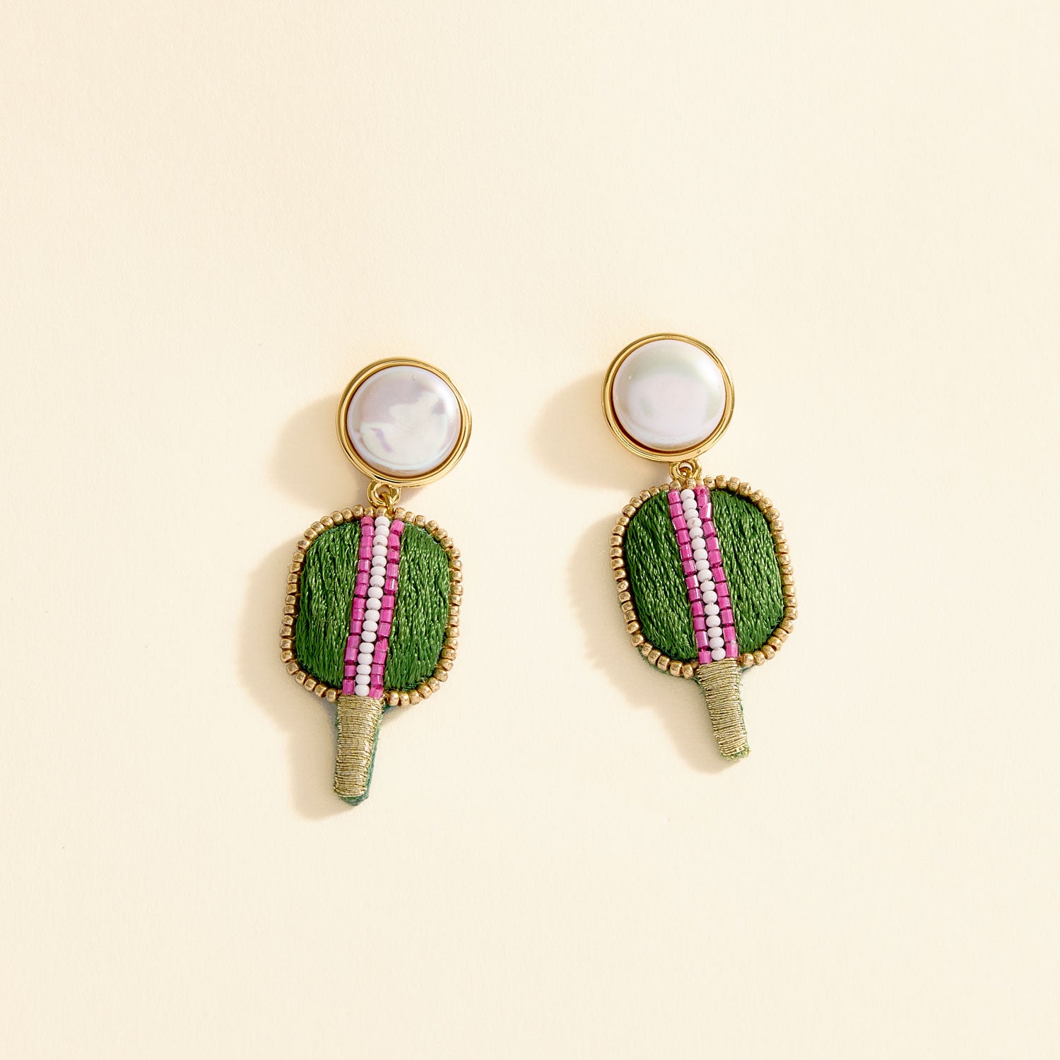 Embroidered Pickleball Racket Drop Earrings on Tan Background