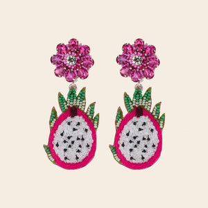 Pink, Green, and White Beaded Dragonfruit Double Drop Earrings on Tan Background