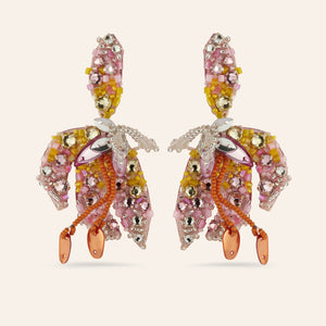 Orange and Pink Crystal and Bead Flower Drop Embroidered Statement Earrings on Tan Background