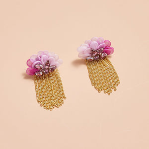 Pink Petal Topped Earrings with Pink Crystals and Gold Chain Stud Earrings on Tan Background