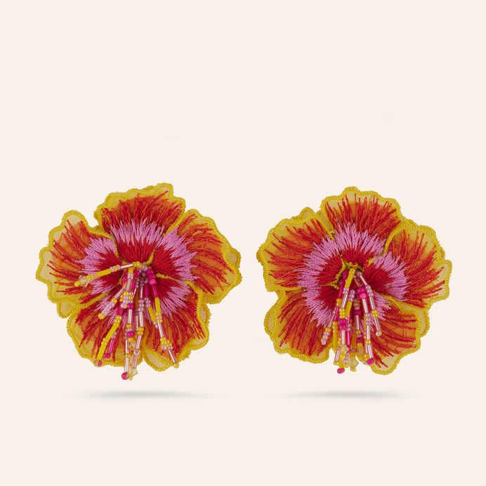 Pink, Yellow, and Red Embroidered Flower Stud Earrings on Tan Background
