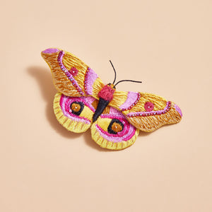 Yellow, Pink, Orange Beaded and Embroidered Butterfly Brooch on Tan Background