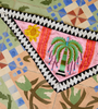 Decorative quilt with embroidered elements on a patterned fabric background