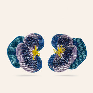 Purple, Blue, and Yellow Beaded Pansy Flower Stud Earrings on Tan Background