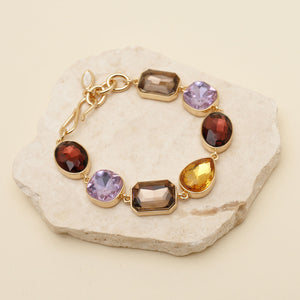 Multi-Colored Crystal Chain Bracelet Staged on Stone with Tan Background